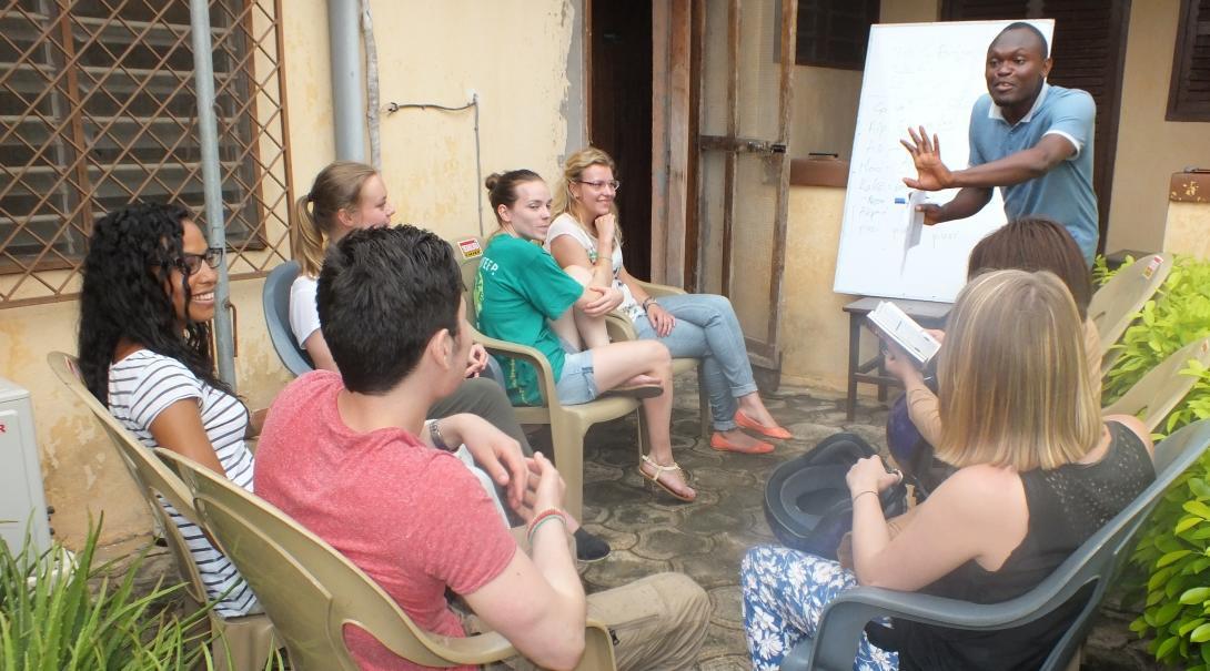 A group of Projects Abroad volunteers learn a local language during one of our language immersion programmes. Volunteers listen intently to their dedicated tutor to help them learn a language abroad.